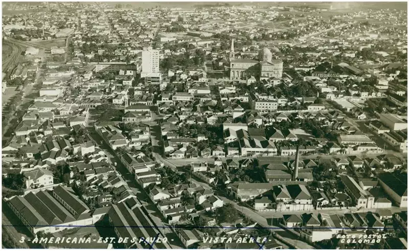 Foto 17: Vista aérea da cidade : [Edifício Abdo Najar : Basílica de Santo Antônio de Pádua] : Americana, SP
